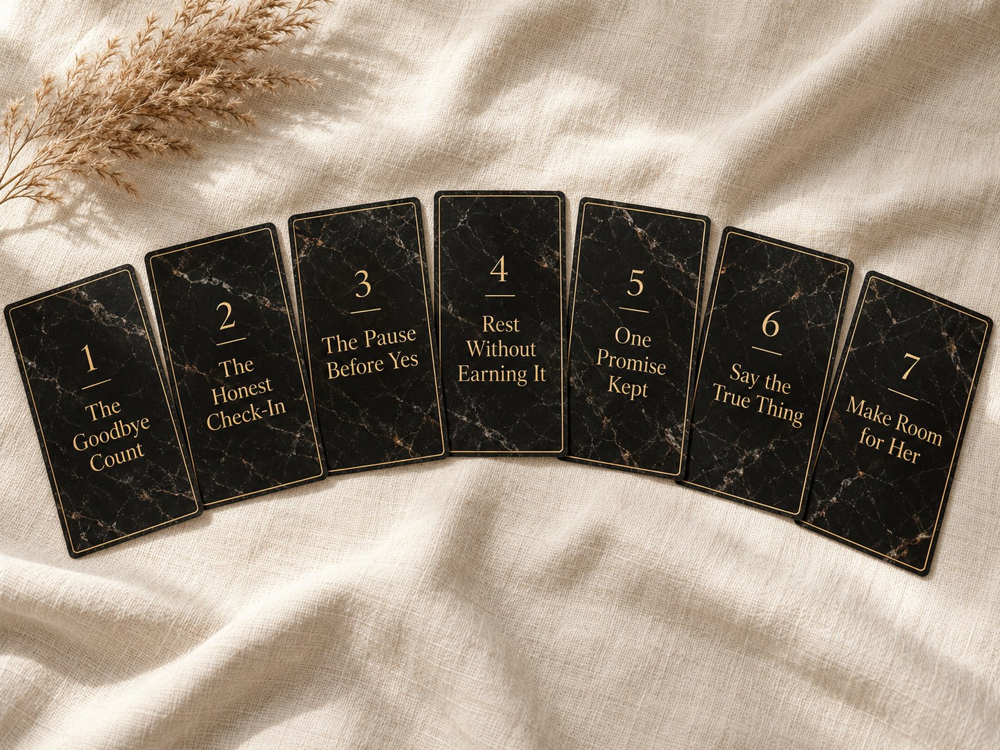 Seven black and gold cards fanned out, each with the name of a Come-Back Ritual